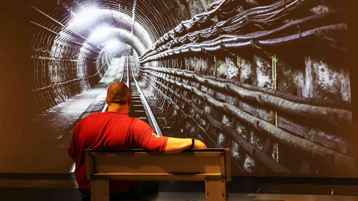 man watching digital projection mail rail tunnel