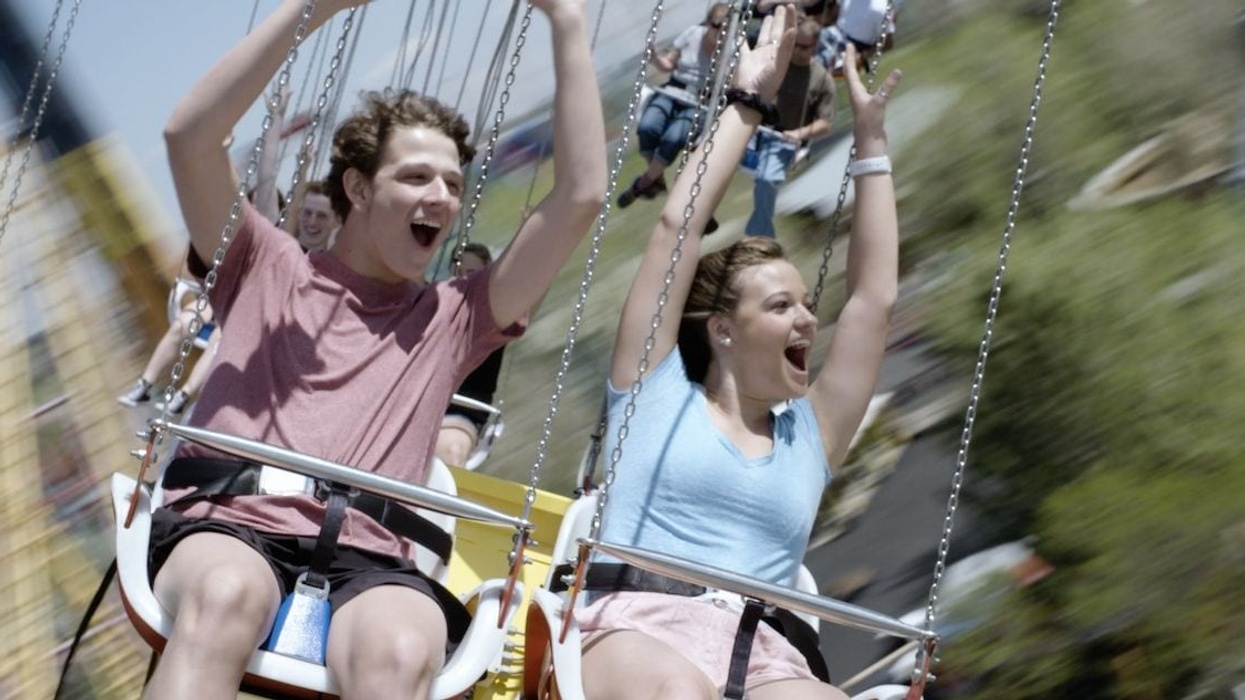 mand and woman on star flyer ride entertainment funtime attraction