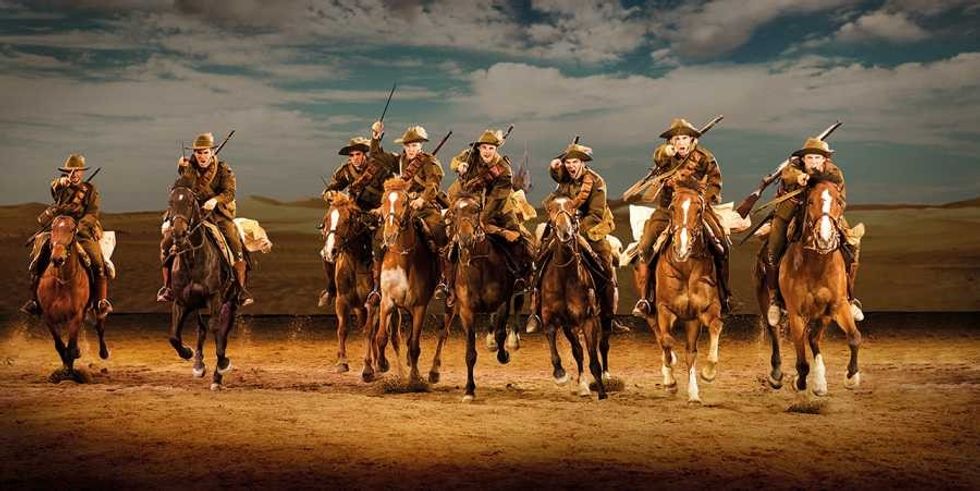 men charge on horseback in australian outback spectacular