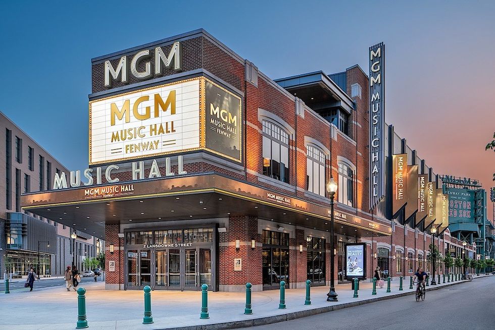 MGM Music Hall at Fenway with lit marquee, at sunset, Boston.