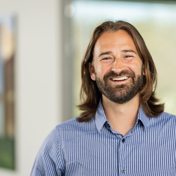 Michael Clifford Headshot in a blue shirt