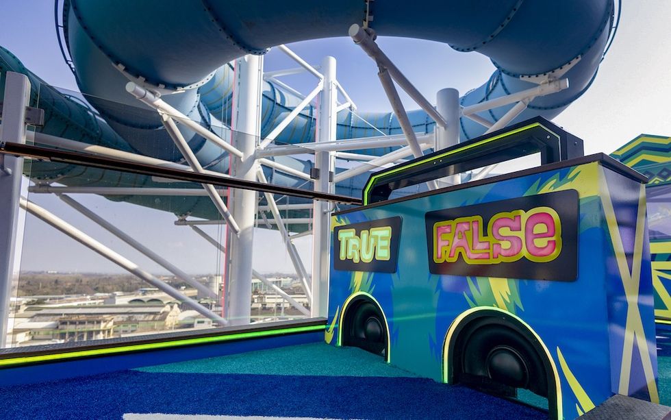 Mini golf holes with "True" and "False" signs and blue tubes in the background.