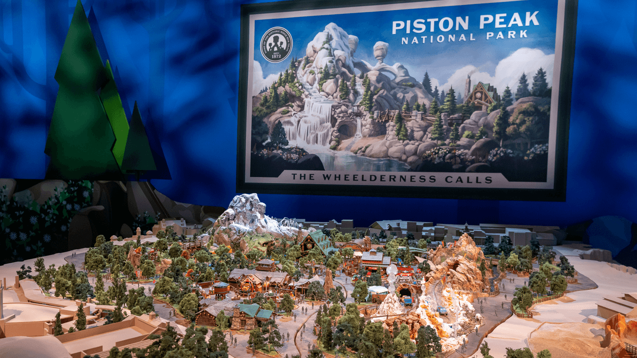 Miniature model of Piston Peak National Park at Magic Kingdom with scenic backdrop.