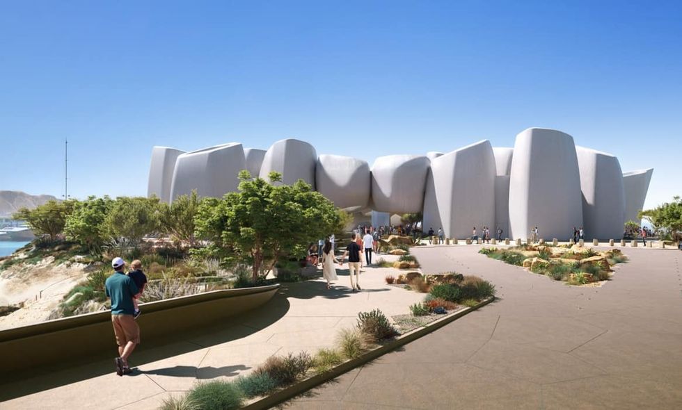 Modern architectural building with curved design, surrounded by paths and greenery at Amaala