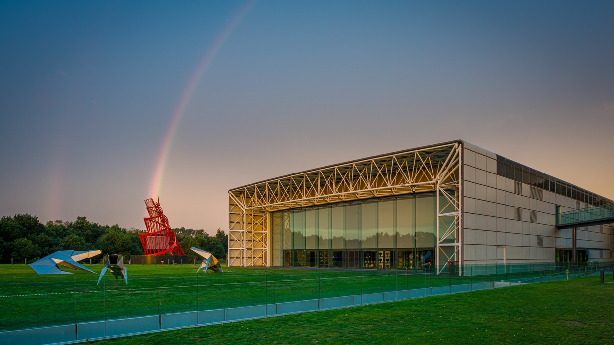 Modern building called the Sainsbury Centre in Norwich with sculptures and a rainbow in the background