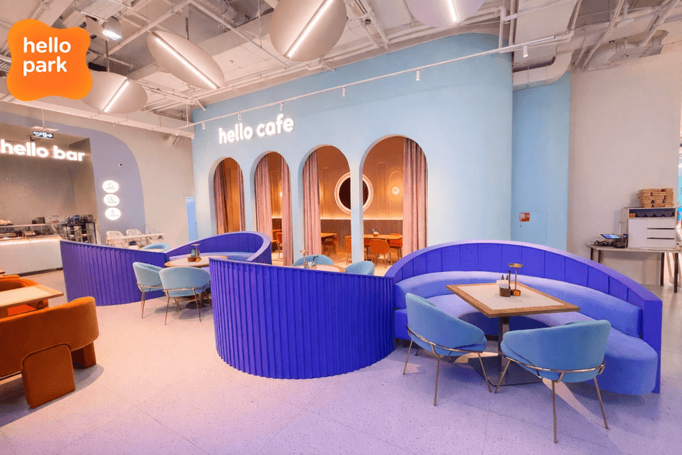 Modern cafe with blue and orange seating, labeled "hello cafe" and "hello bar."