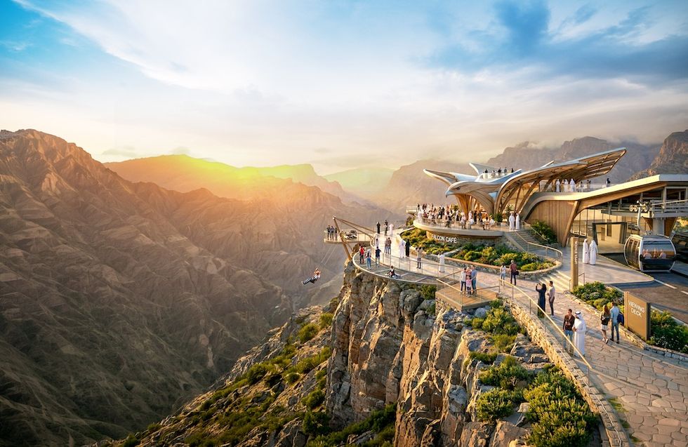 Modern cliffside cafe and viewing deck overlooking a vast, sunlit mountain landscape.