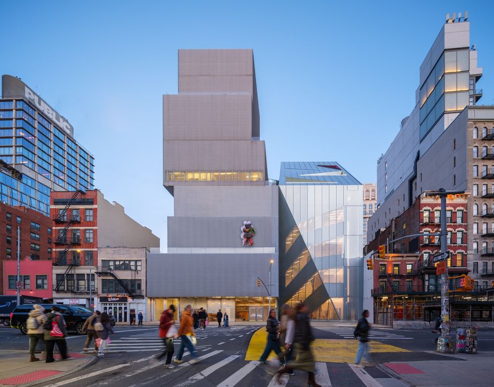 Modern geometric New Museum building on a city street with people walking in the foreground.