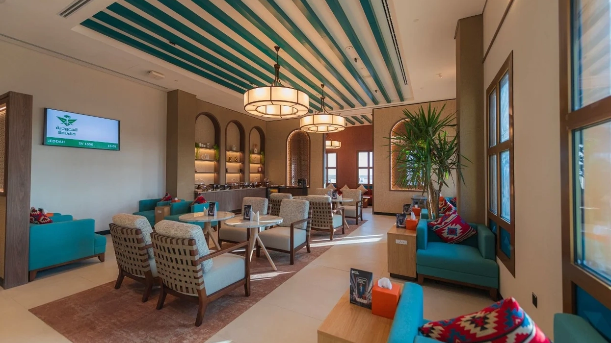 Modern lounge at Saudi Arabia's Al-Wajh International Airport with teal accents, cozy seating, and a bright, inviting atmosphere.