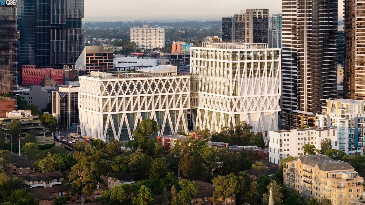 Modern skyline with distinctive crisscross-patterned building called Powerhouse Parramatta surrounded by greenery