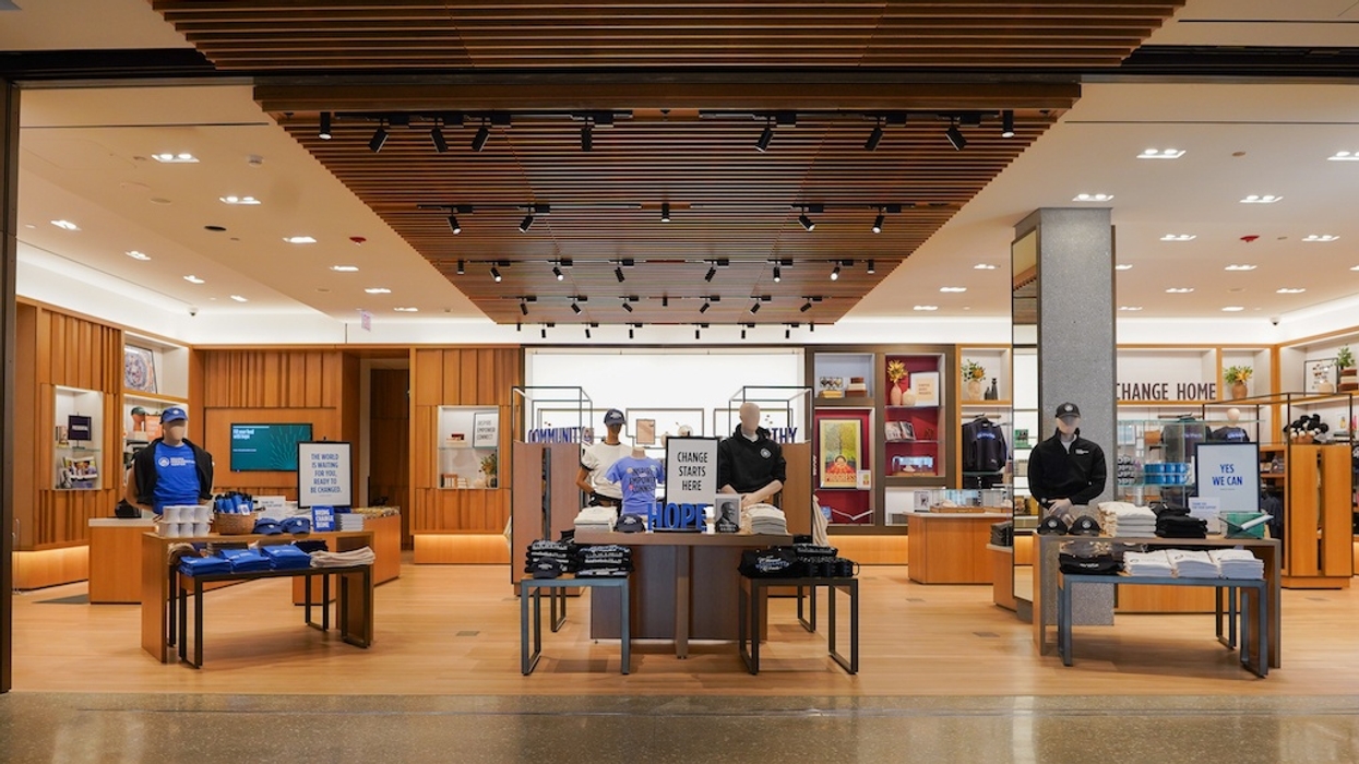 Modern store interior at Obama Presidential Center with merchandise tables and mannequins, featuring clothing and accessories.