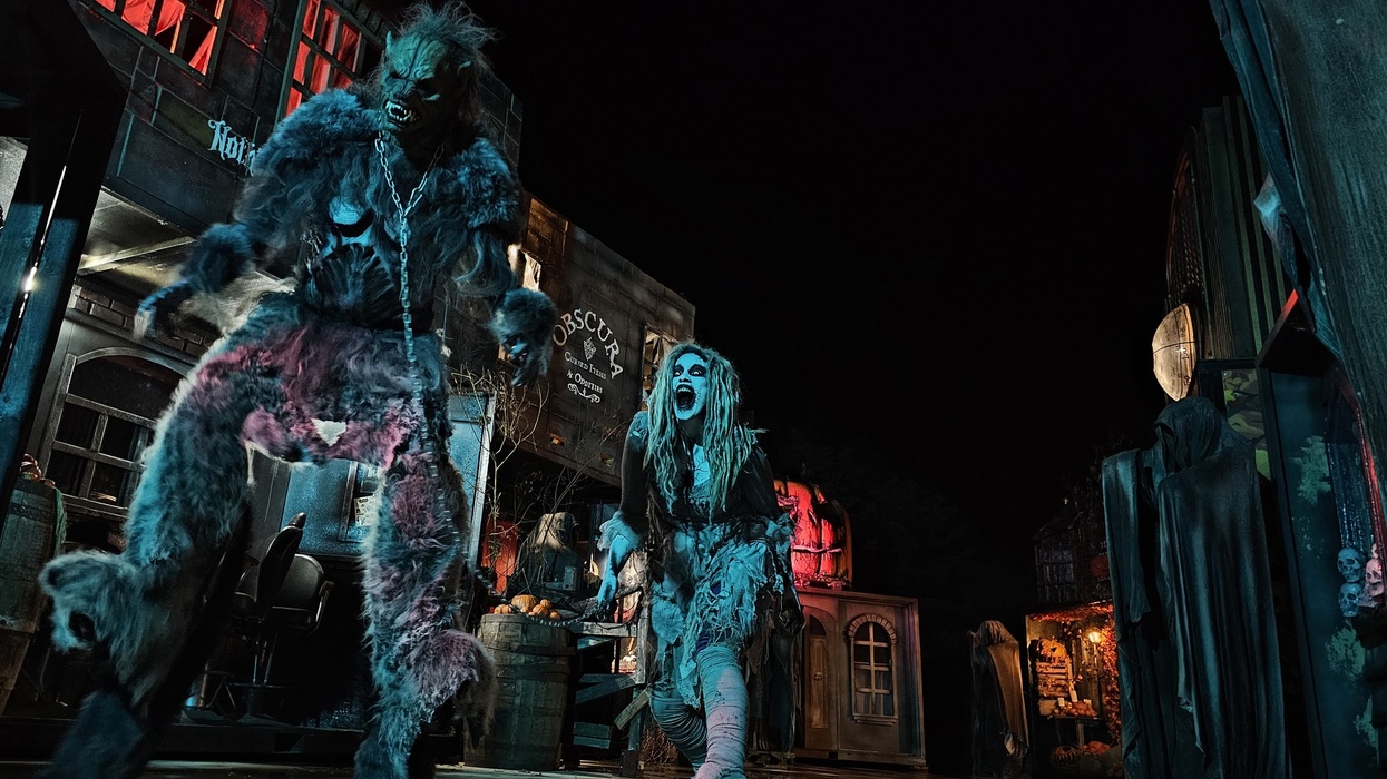 Monsters in a haunted street scene with eerie lighting and spooky decor.