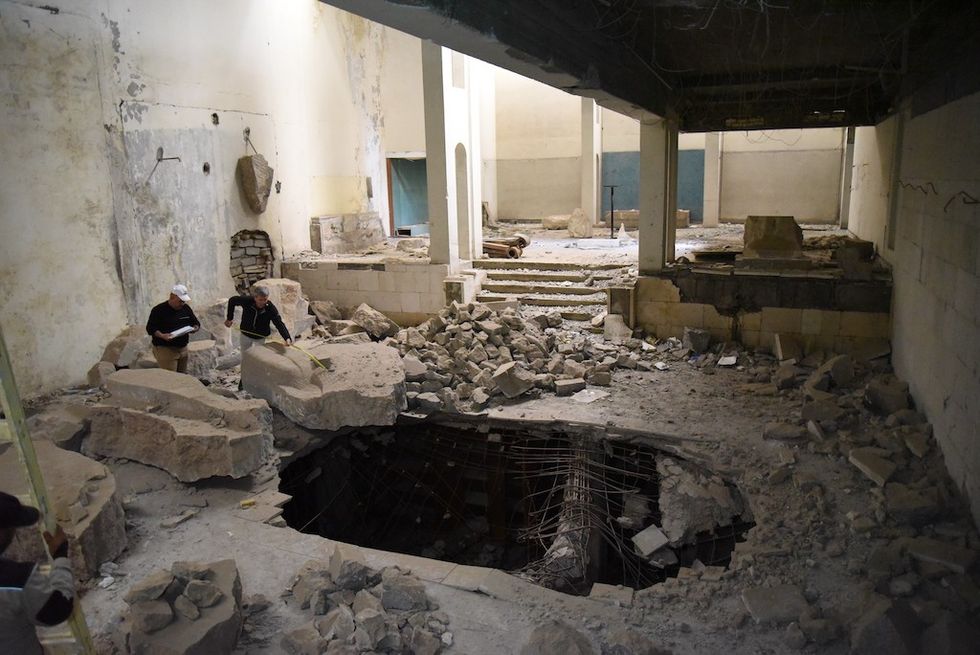 Mosul Cultural Museum staff documenting the damage in the Assyrian Hall (2019)