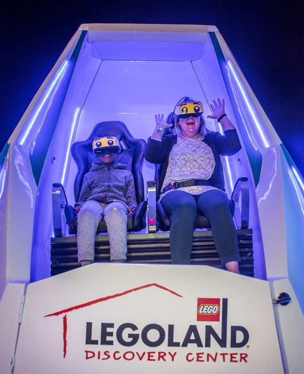 mother and boy enjoy immotion vr experience at legoland discovery center boston