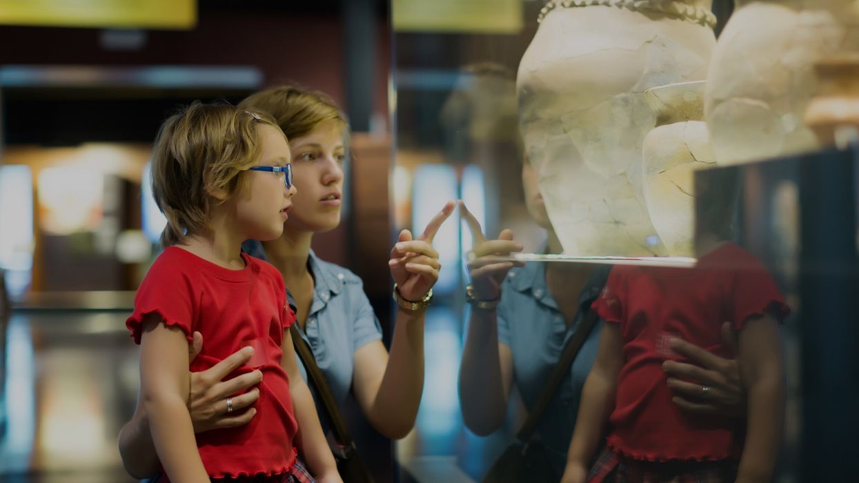 mother and child looking ancient amphores in museum