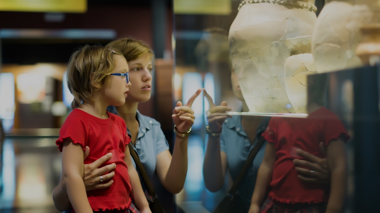 mother and child looking ancient amphores in museum