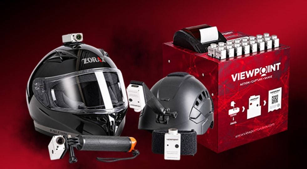 Motorcycle and tactical helmets with cameras and Viewpoint capture station on red background.