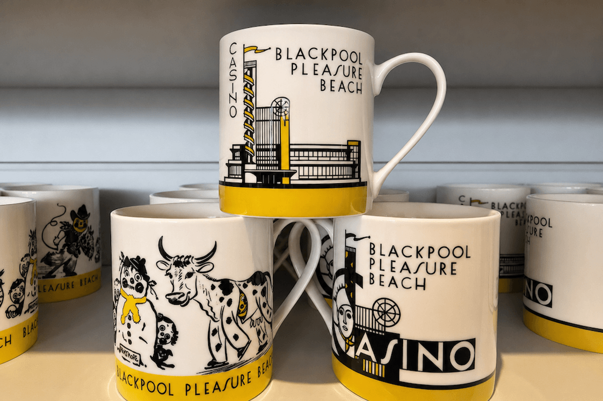 Mugs with "Blackpool Pleasure Beach" design and various illustrations on a shelf.