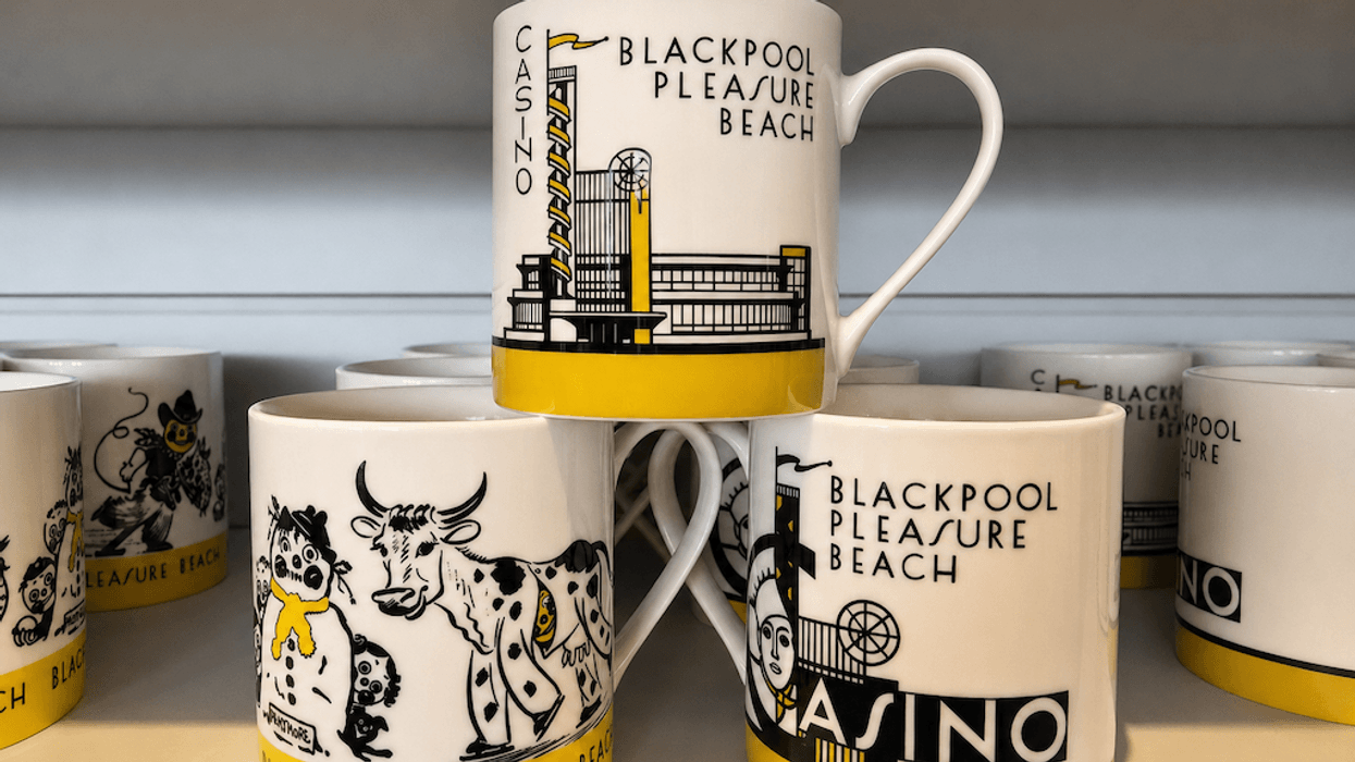 Mugs with "Blackpool Pleasure Beach" design and various illustrations on a shelf.