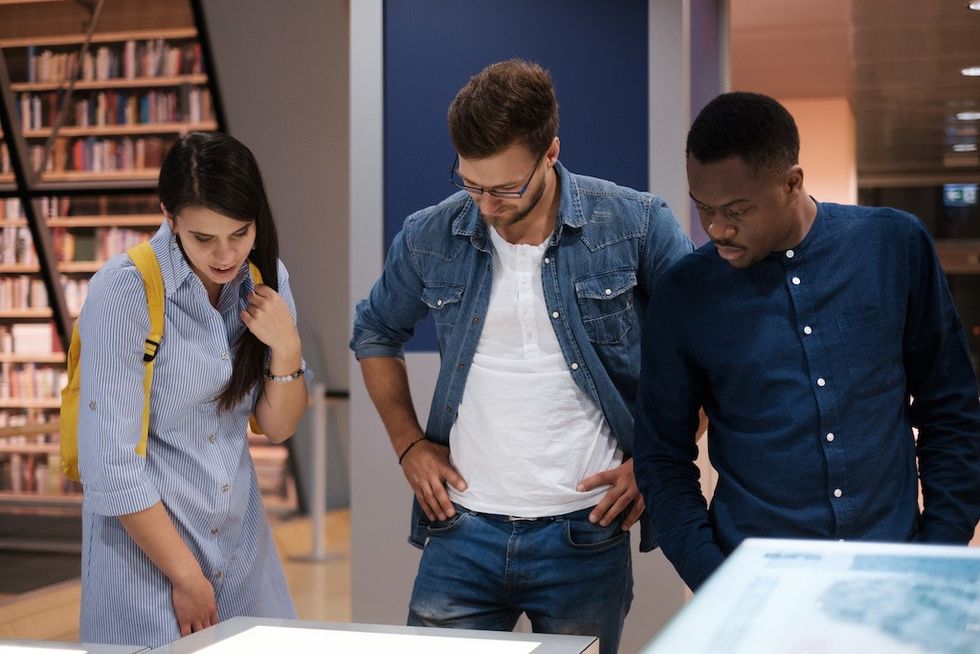 Multicultural group of students in a public library