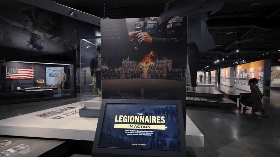 Museum exhibit featuring military displays and a "Legionnaires in Action" interactive screen at the Tennessee Wings of Liberty Museum