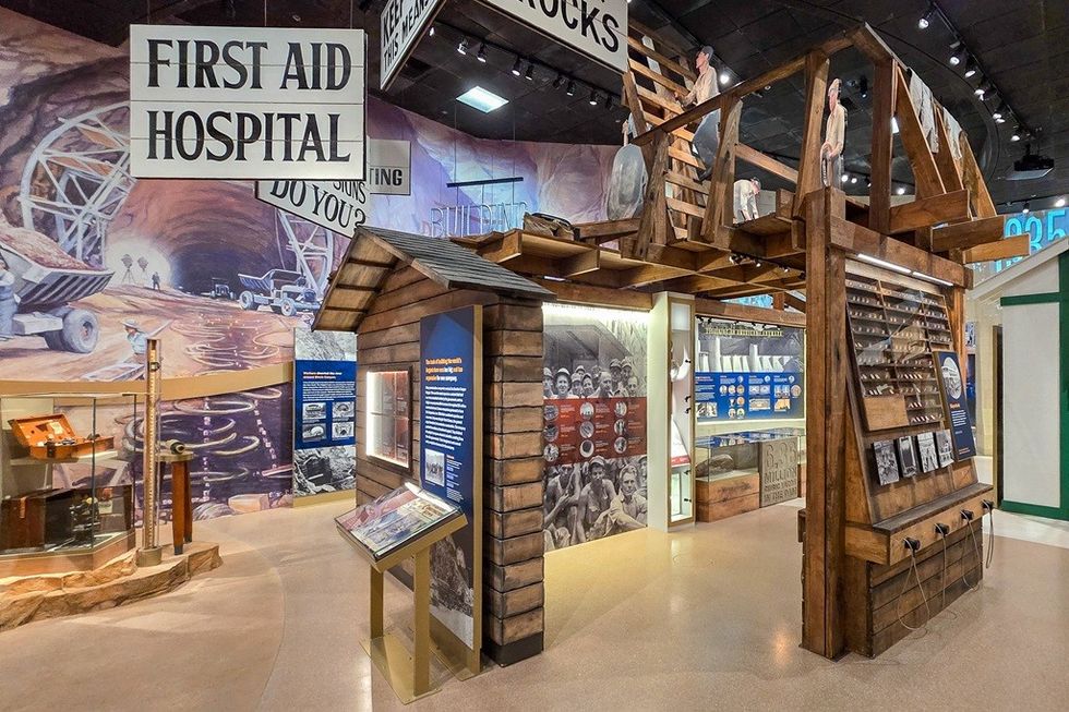 Museum exhibit with a first aid hospital sign and mining displays.
