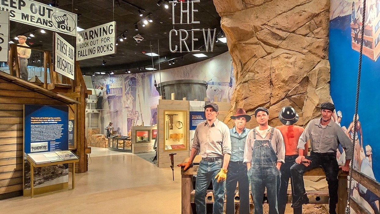 Museum exhibit with miner cutouts and vintage safety signs.