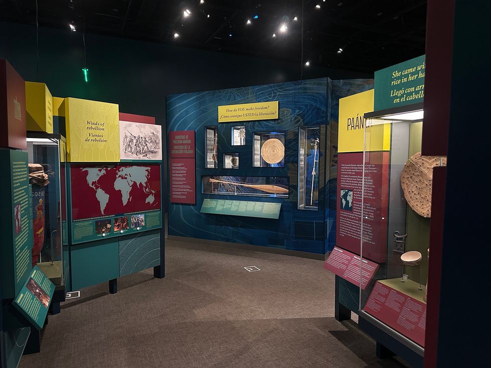 Museum exhibition featuring historical artifacts, maps, and educational displays.