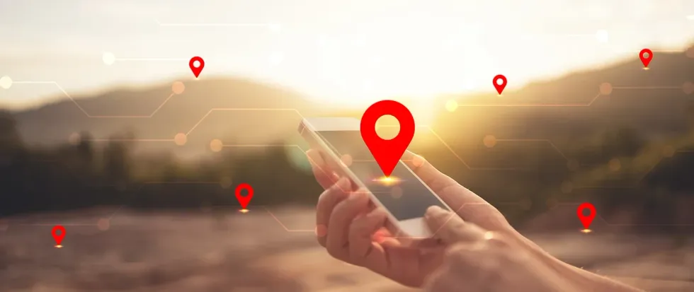 n-gage.io. Hand holding a mobile phone with an overlay of location marker and links