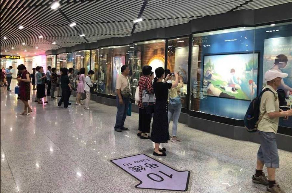 National Gallery Shanghai Metro commuters browsing the exhibition