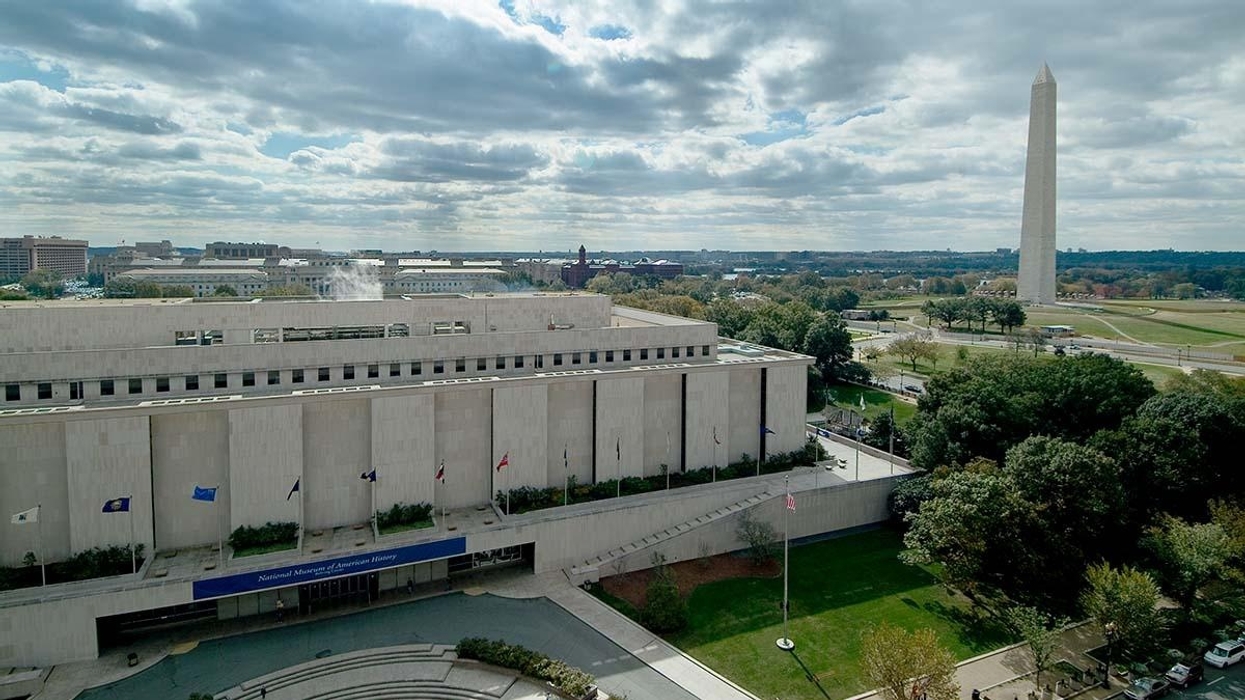 National Museum of American History and Washington Monument under a cloudy sky.