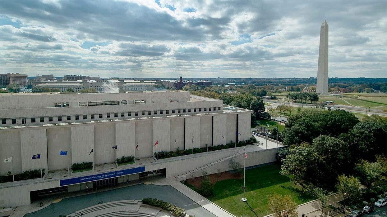National Museum of American History and Washington Monument under a cloudy sky.