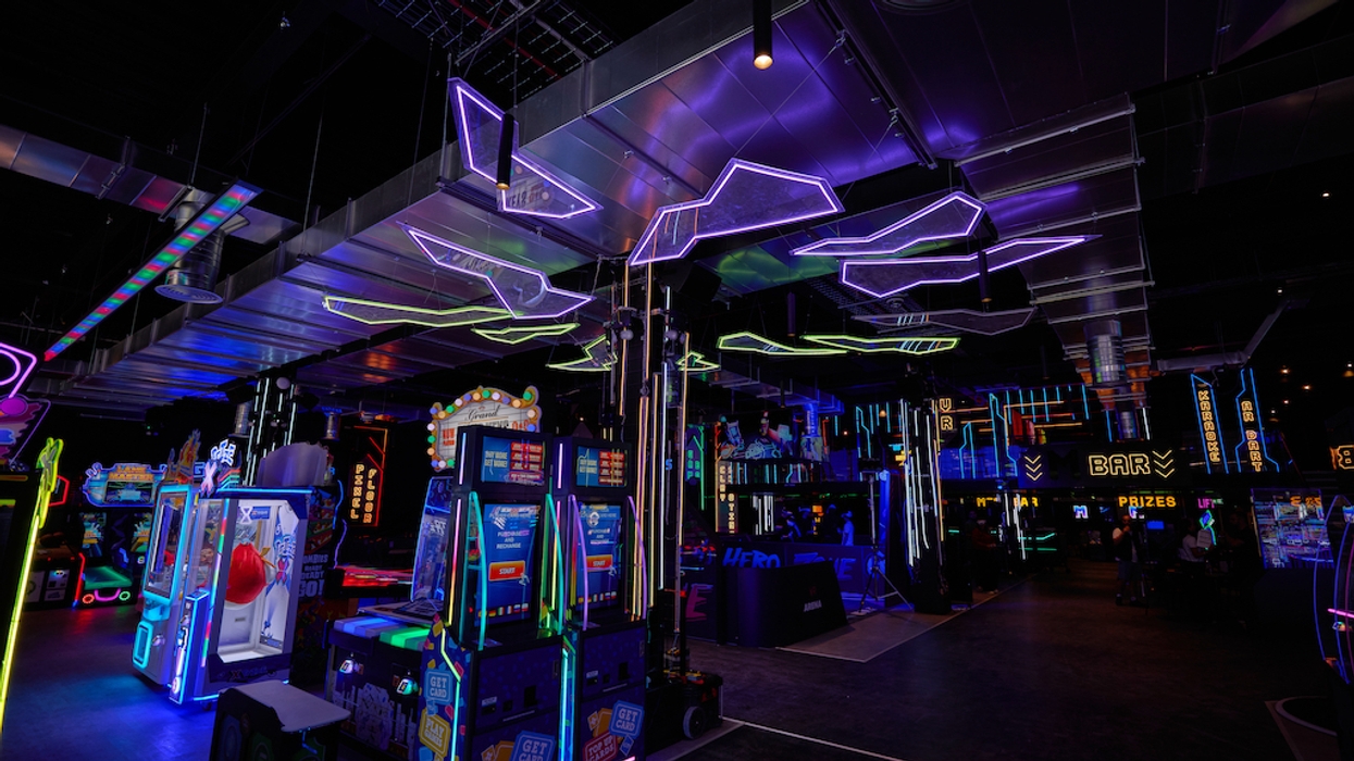 Neon-lit arcade interior with games and glowing signs.