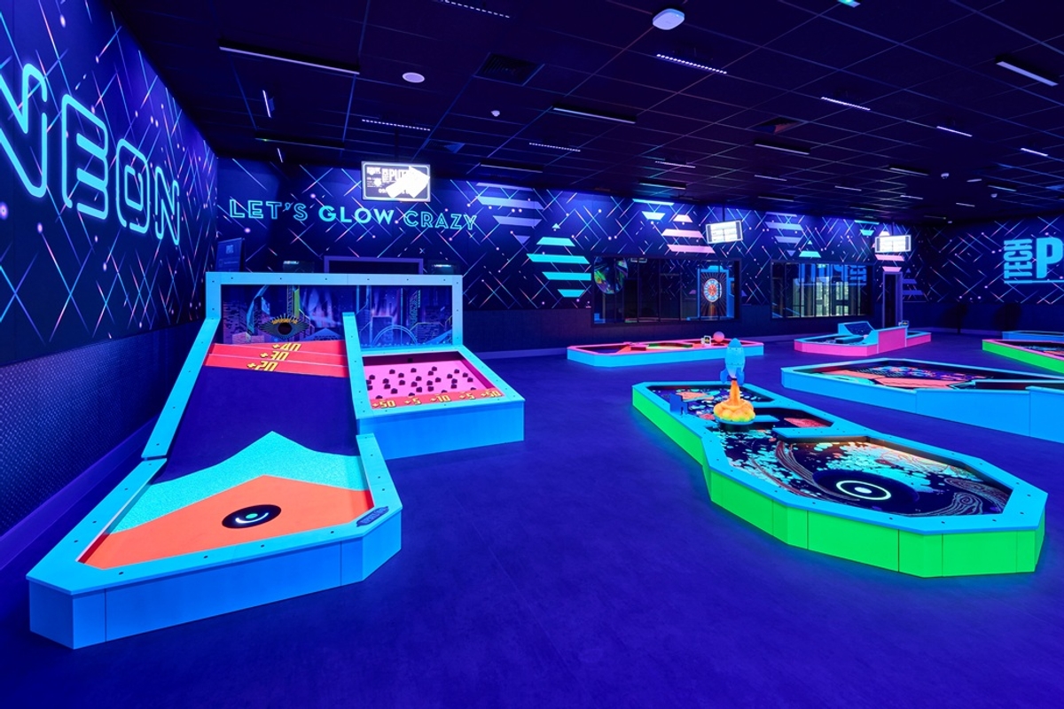 Neon-lit indoor mini golf course from 360Golf with vibrant colours and futuristic designs.