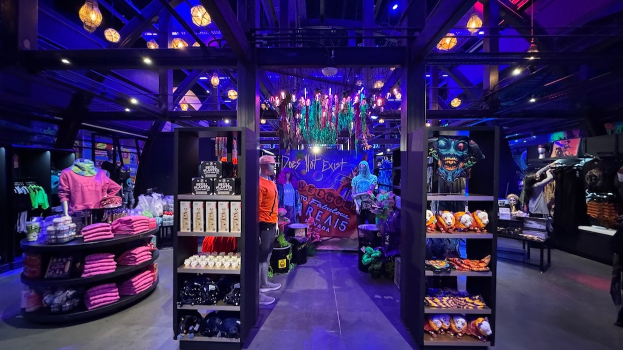 Neon-lit store interior with spooky decorations and colorful merchandise displays.