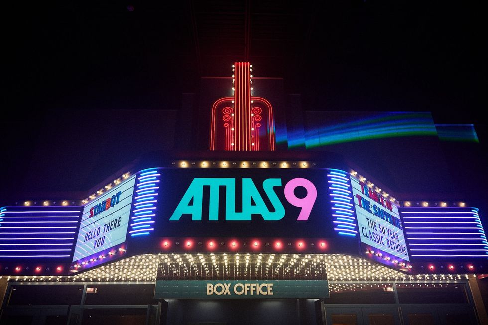 Neon-lit theater entrance with marquee "ATLAS 9" and retro-styled designs.