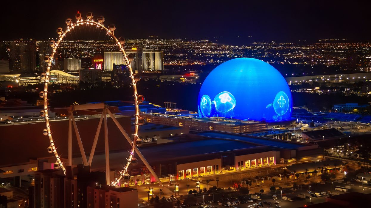 New MSG Sphere in Las Vegas next to High Roller wheel at night