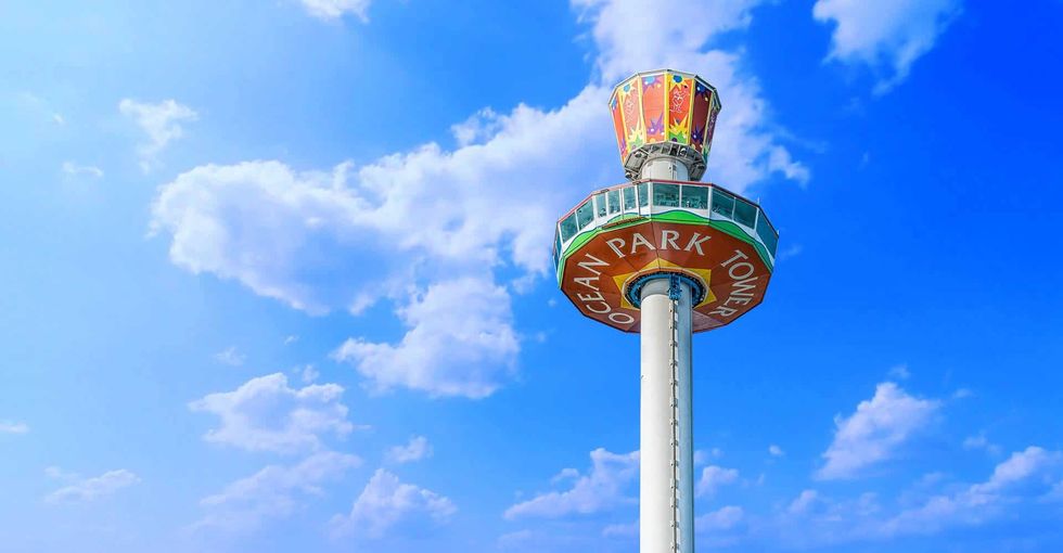 Ocean Park Tower against a vibrant blue sky with scattered clouds.