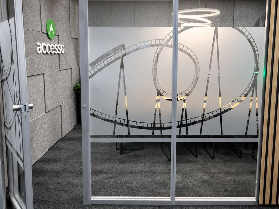 Office with frosted glass door featuring roller coaster design.