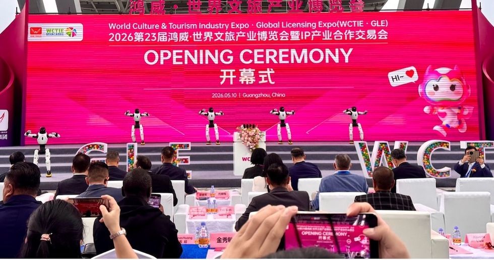 Opening ceremony at AAA 2026 with robots on stage and audience seated.