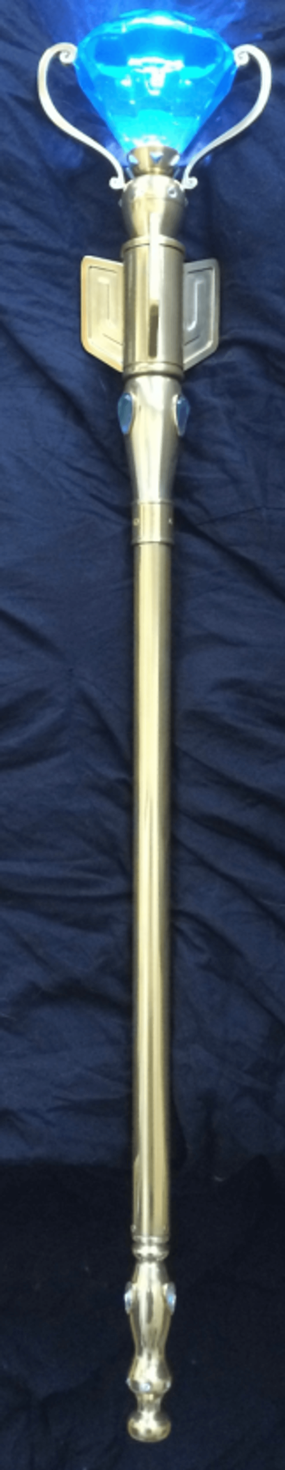 Ornate golden staff with glowing blue crystal orb on a dark background.