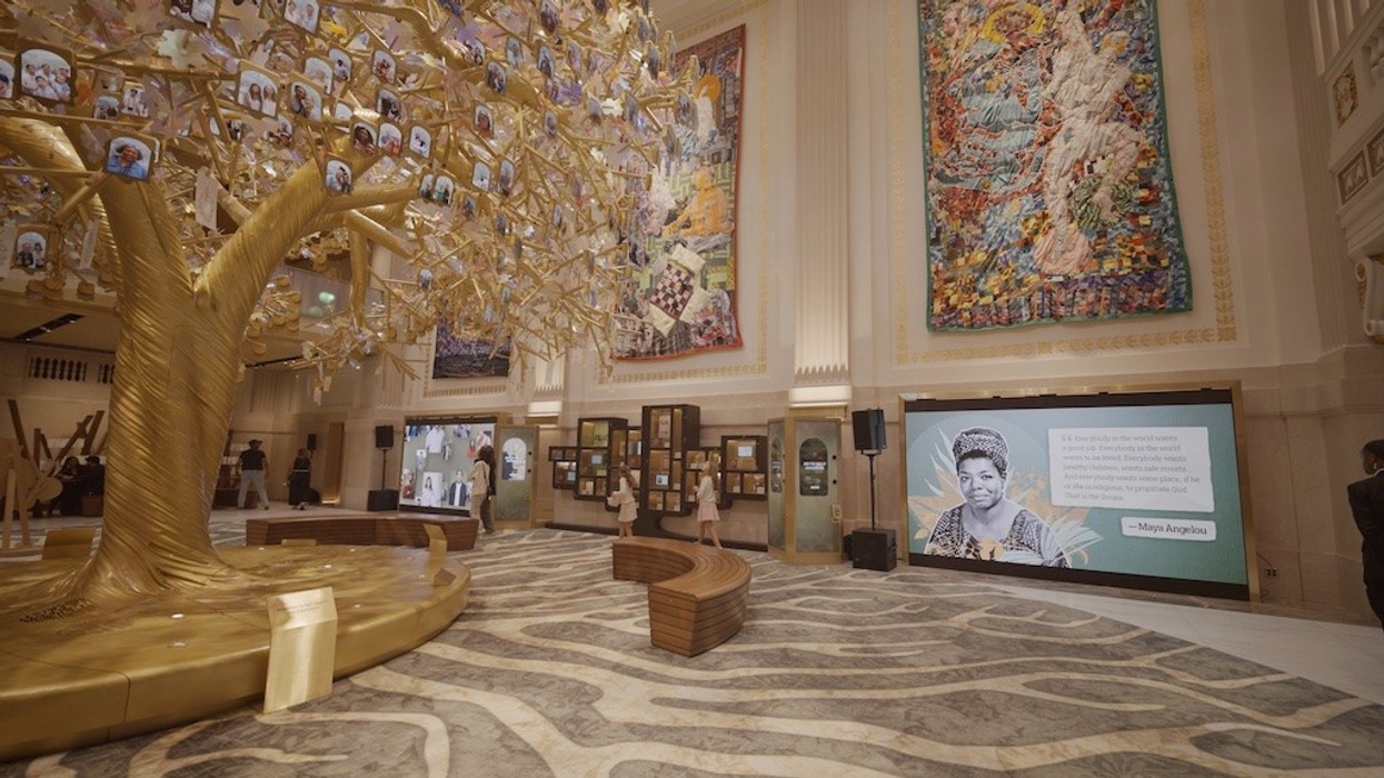 Ornate hall with golden tree and colorful murals; Maya Angelou quote on screen. the Milken Center for Advancing the American Dream