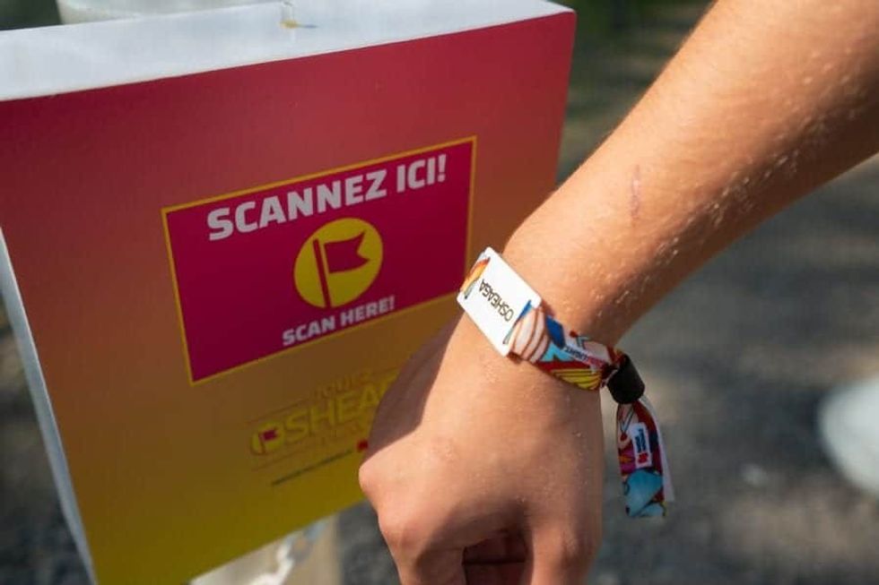 Osheaga Music and Arts Festival guest scanning Connect&GO's RFID wristband at an access point