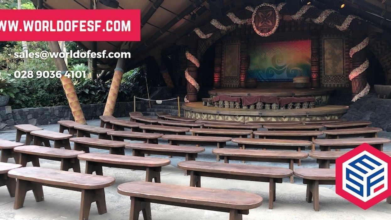 Outdoor stage with wooden benches and contact info overlay.