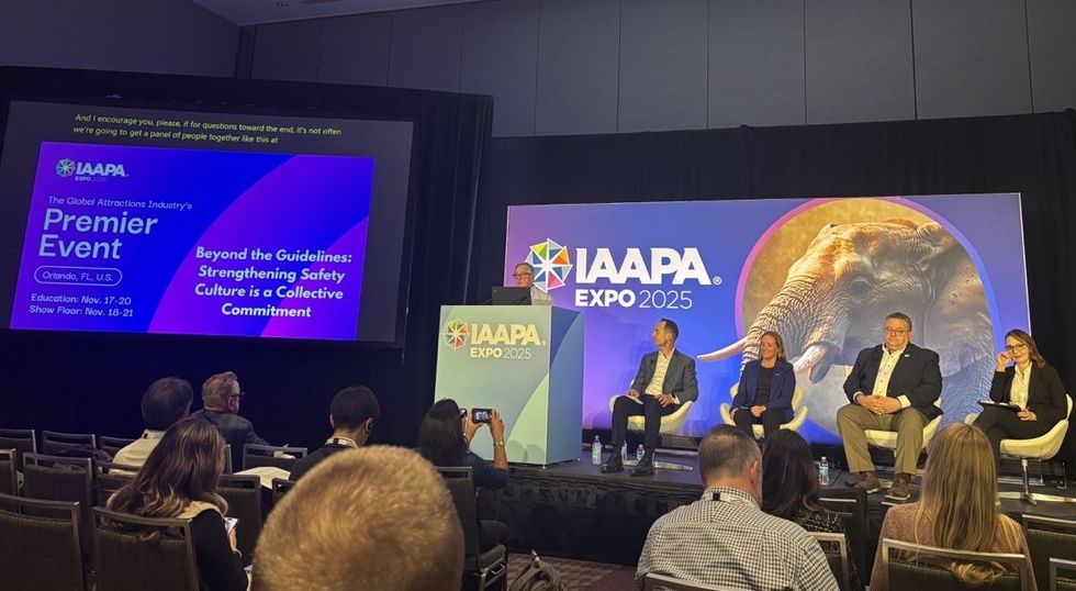 Panel discussion at IAAPA Expo 2025, with speakers seated on stage.