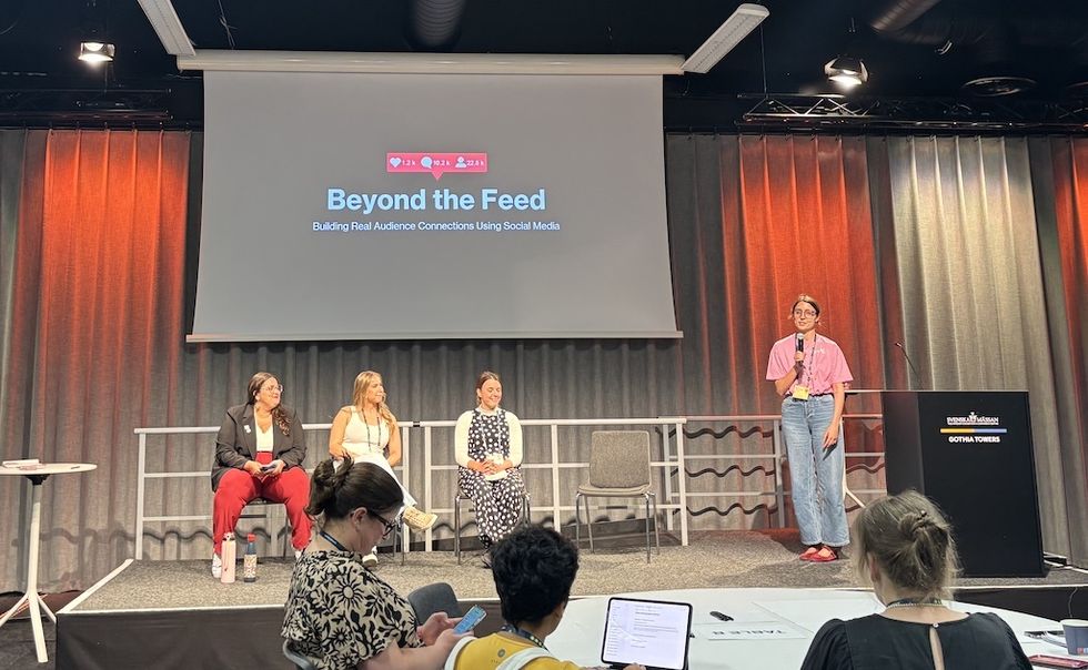 Panel discussion titled "Beyond the Feed" on stage with four speaker at Ecsite 2026