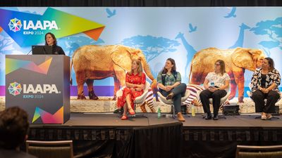 Panelists at IAAPA Expo 2024 with a safari-themed backdrop.