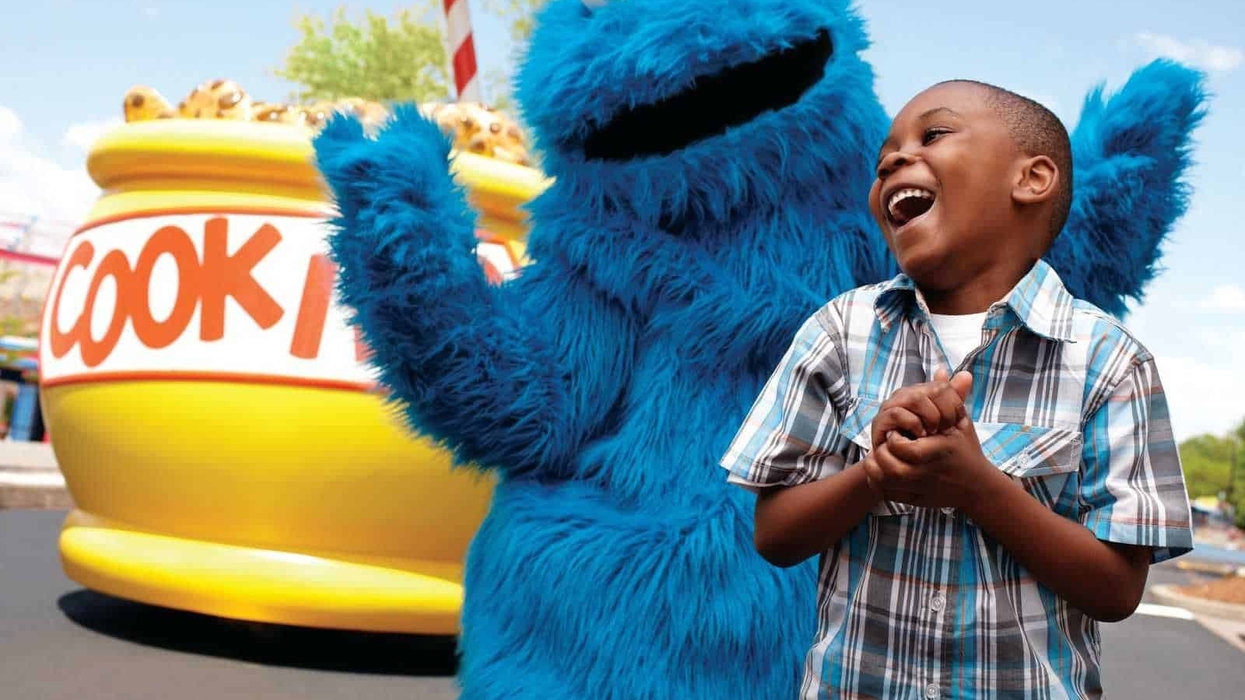 Parade Cookie Monster takes a photo with a laughing boy