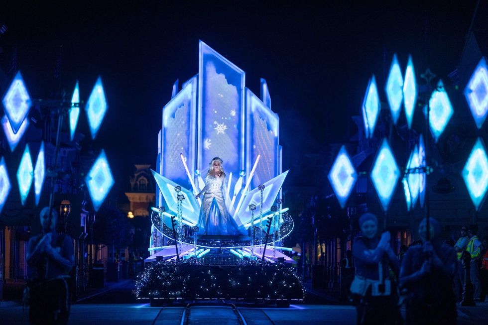 Parade float with ice theme and blue lights glowing at night.
