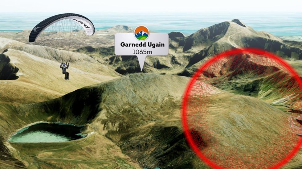 Paraglider over Garnedd Ugain mountain with height marker, highlighted area, and lake view.